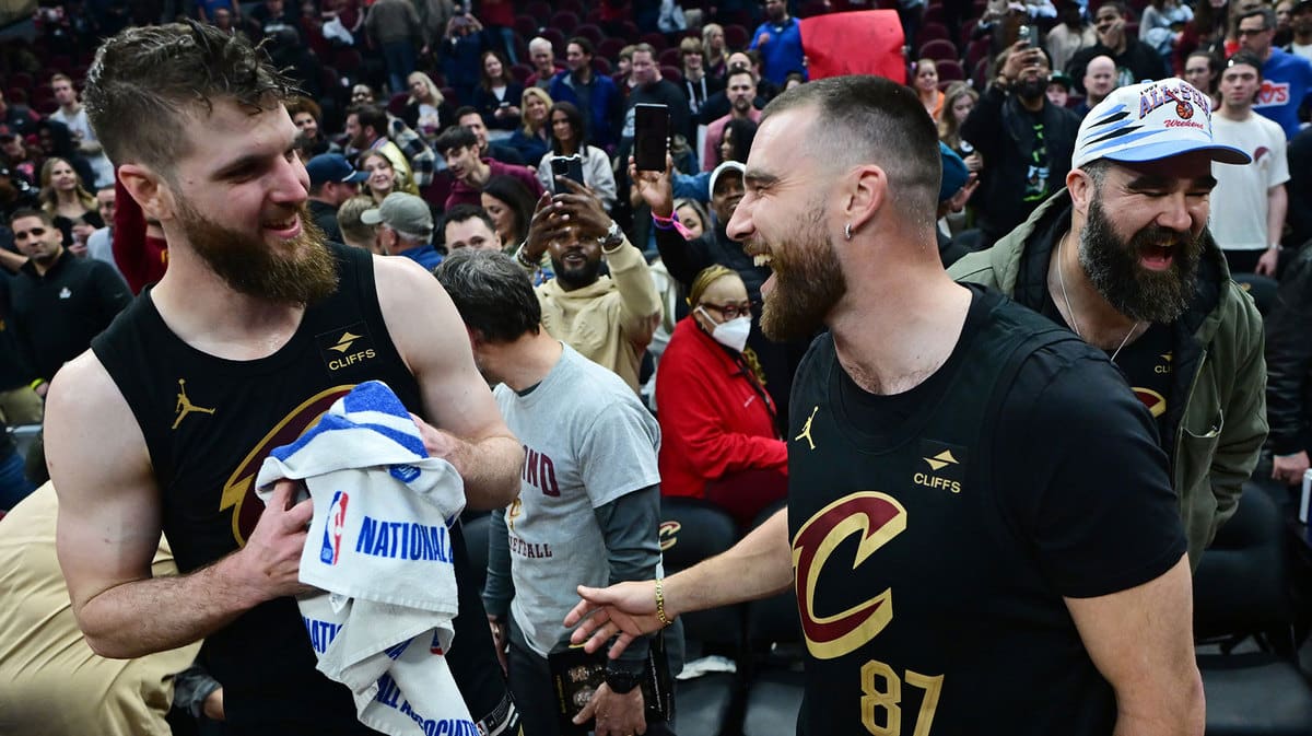 Cleveland Cavaliers forward Dean Wade, left, celebrates with Kansas City Chiefs tight end Travis Kelce and former Philadelphia Eagles center Jason Kelce, right, after the Cavaliers beat the Boston Celtics during the second half at Rocket Mortgage FieldHouse