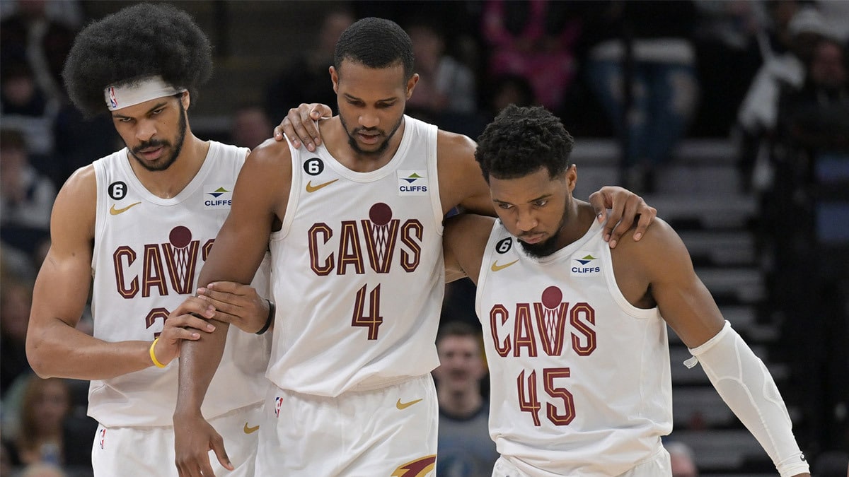 Cleveland Cavaliers forward Evan Mobley (4) is helped off the court by guard Donovan Mitchell (45) and center Jarrett Allen (31) during the second quarter at Target Center.