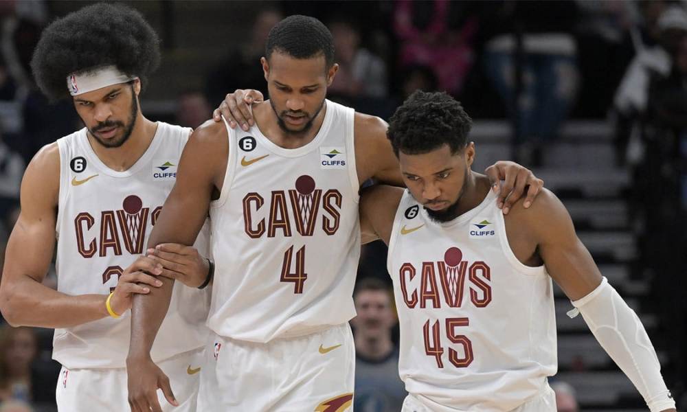 Cleveland Cavaliers forward Evan Mobley (4) is helped off the court by guard Donovan Mitchell (45) and center Jarrett Allen (31) during the second quarter at Target Center.