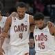Cleveland Cavaliers forward Evan Mobley (4) is helped off the court by guard Donovan Mitchell (45) and center Jarrett Allen (31) during the second quarter at Target Center.