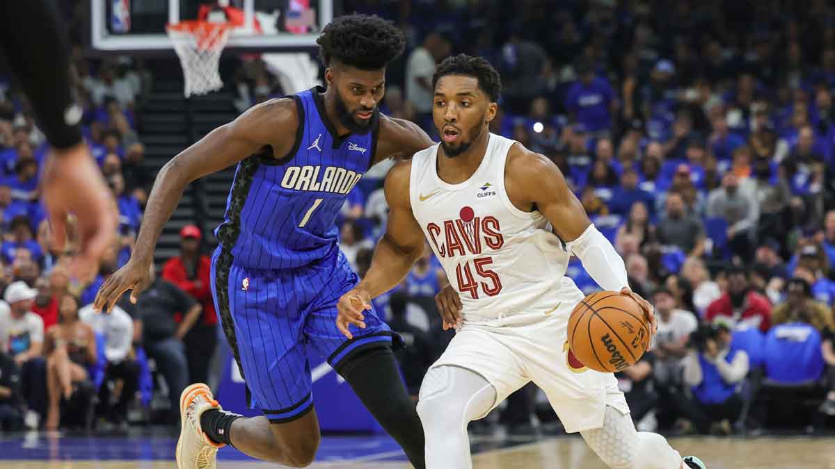 Cleveland Cavaliers guard Donovan Mitchell (45) drives to the basket against Orlando Magic forward Jonathan Isaac (1) during the first quarter of game six of the first round for the 2024 NBA playoffs at Kia Center.