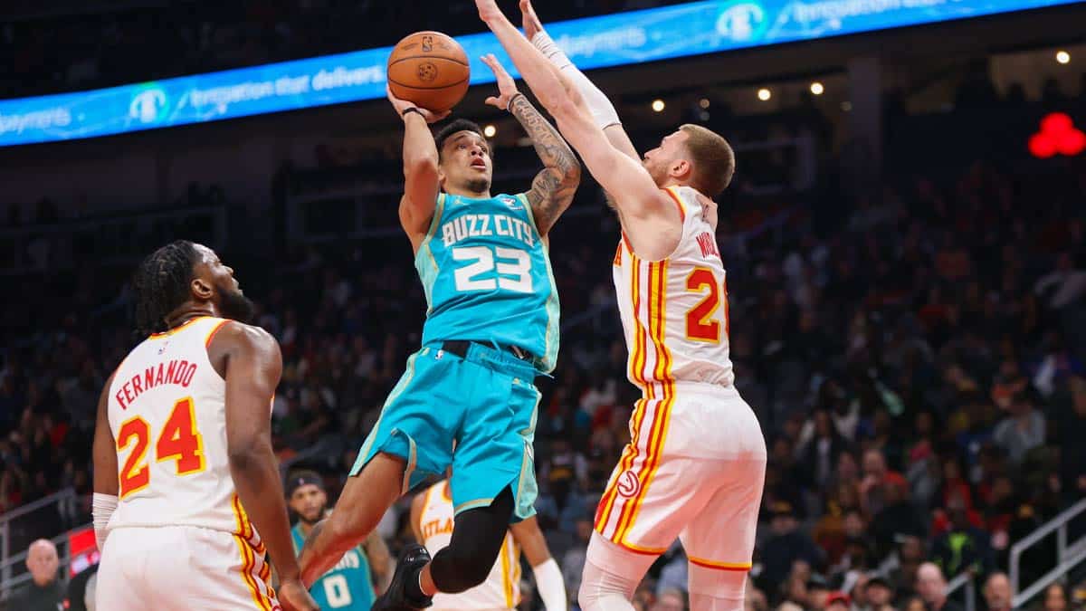 Charlotte Hornets guard Tre Mann (23) shoots past Atlanta Hawks guard and former Cavs first round pick Dylan Windler (20) in the second half at State Farm Arena.