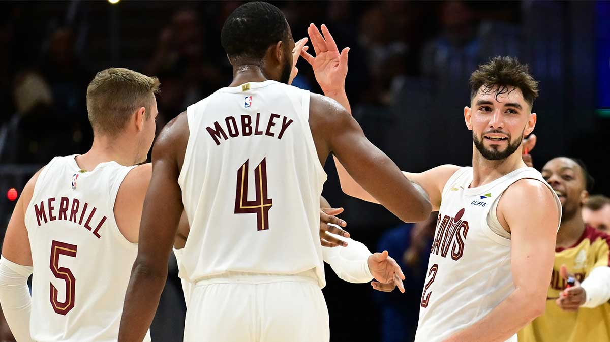 Cavaliers guard Ty Jerome (2) celebrates after hitting a three point basket with guard Sam Merrill (5) and forward Evan Mobley (4) during the second half against the Toronto Raptors at Rocket Mortgage FieldHouse