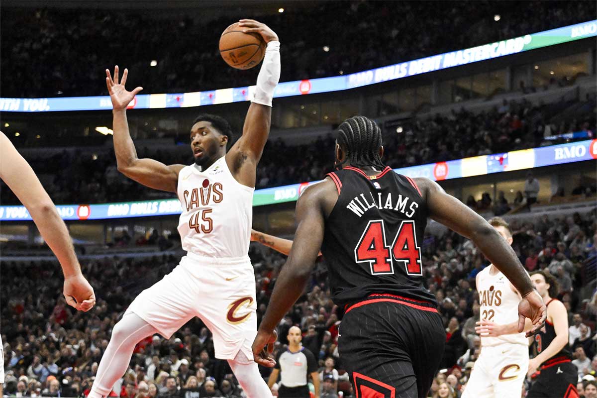 Cleveland Cavaliers guard Donovan Mitchell (45) grabs a rebound away from Chicago Bulls forward Patrick Williams (44) during the second half at United Center.