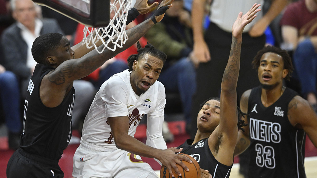 Cleveland Cavaliers guard Darius Garland (10) drives between three Brooklyn Nets defenders in the third quarter at Rocket Mortgage FieldHouse.