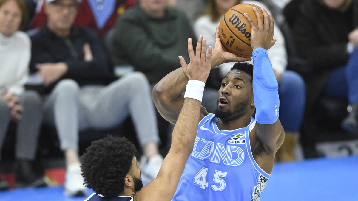 Cavaliers guard Donovan Mitchell (45) shoots beside Denver Nuggets guard Jamal Murray (27) in the third quarter at Rocket Mortgage FieldHouse