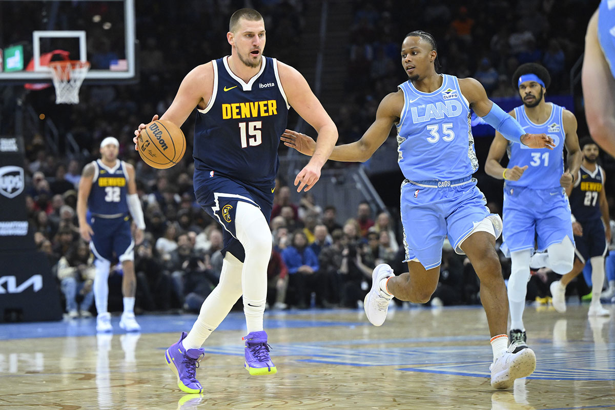 Nikola Jokic (15) brings the ball up court beside Cleveland Cavaliers forward Isaac Okoro (35) in the second quarter at Rocket Mortgage FieldHouse