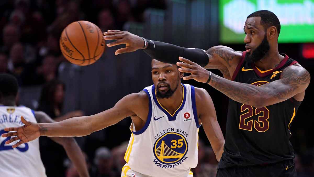 Cleveland Cavaliers forward LeBron James (23) passes the ball against Golden State Warriors forward Kevin Durant (35) during the second quarter in game four of the 2018 NBA Finals at Quicken Loans Arena.