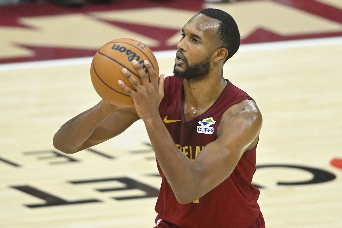 Cavs forward Evan Mobley (4) shoots a three-point basket in the fourth quarter against the Charlotte Hornets at Rocket Mortgage FieldHouse