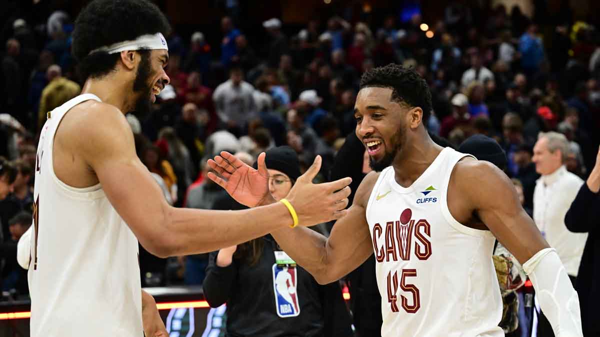 Cavs guard Donovan Mitchell (45) celebrates with center Jarrett Allen (31)