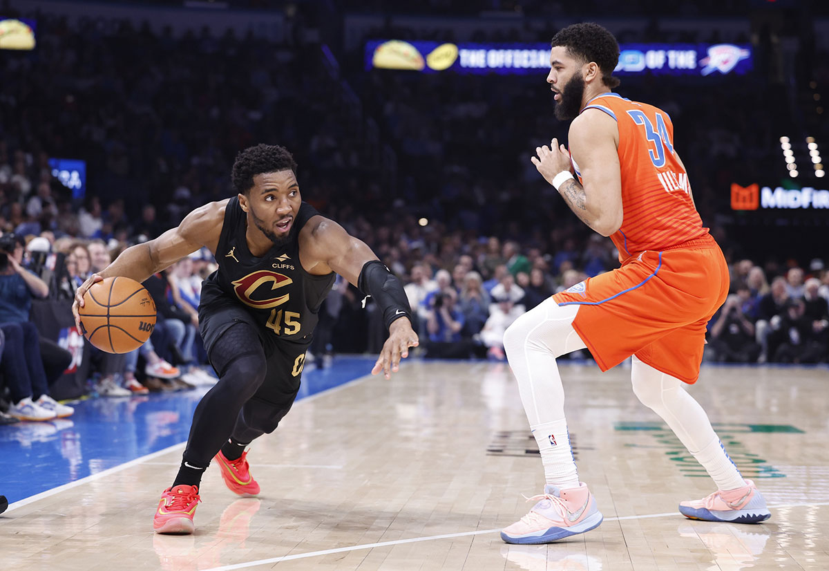 Cleveland Cavaliers guard Donovan Mitchell (45) drives around Oklahoma City Thunder forward Kenrich Williams (34) during the second quarter at Paycom Center. 