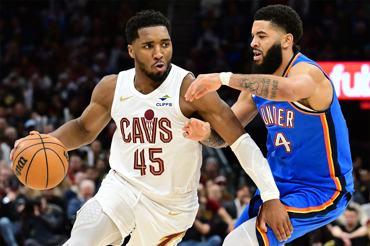 Cleveland Cavaliers guard Donovan Mitchell (45) drives to the basket against Oklahoma City Thunder forward Kenrich Williams (34) during the second half at Rocket Mortgage FieldHouse. 