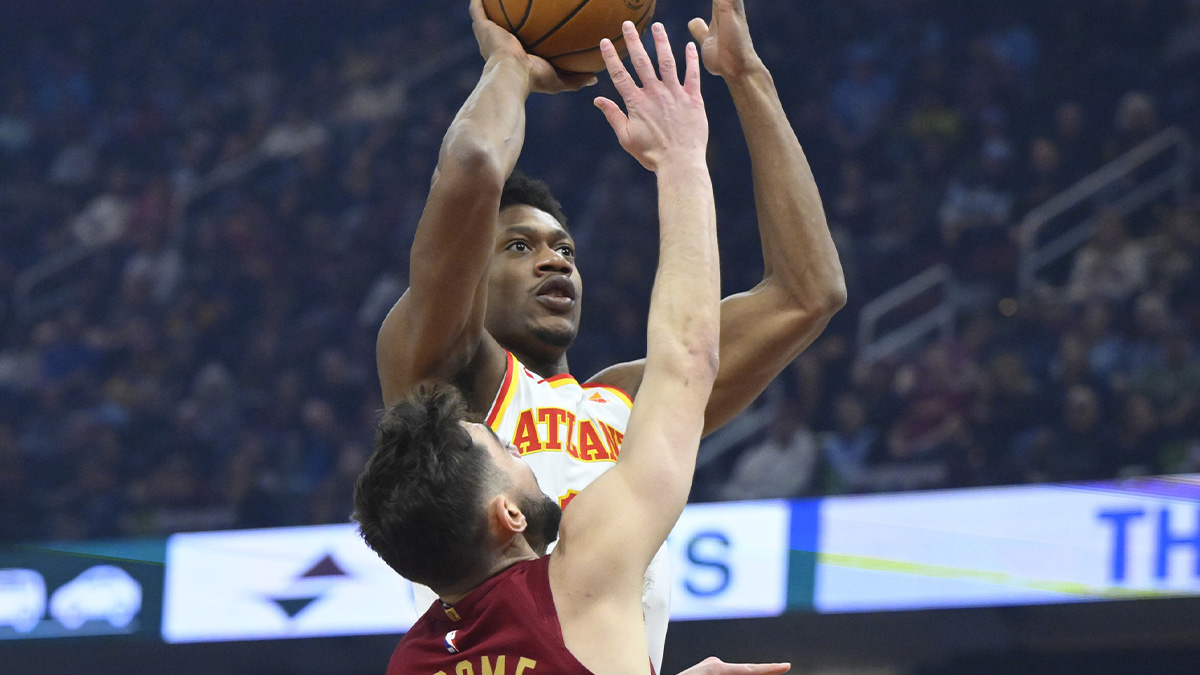 Atlanta Hawks forward De'Andre Hunter (12) shoots beside Cleveland Cavaliers guard Ty Jerome (2) in the first quarter at Rocket Mortgage FieldHouse.