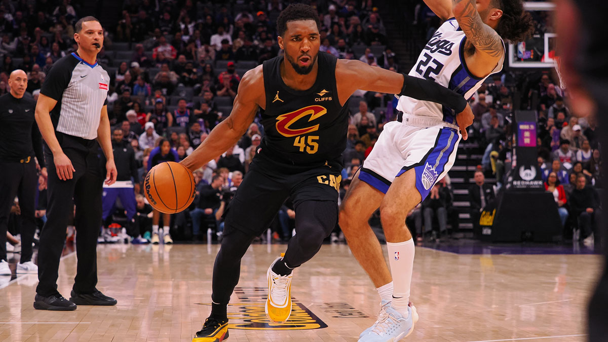 Cleveland Cavaliers guard Donovan Mitchell (45) dribbles around Sacramento Kings guard Devin Carter (22) during the fourth quarter at Golden 1 Center. 