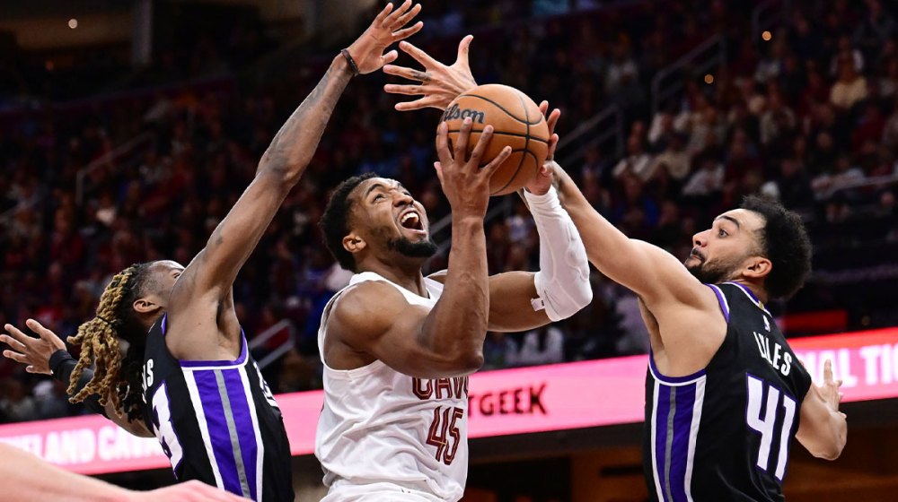 Cleveland Cavaliers guard Donovan Mitchell (45) drives to the basket between Sacramento Kings guard Keon Ellis (23) and forward Trey Lyles (41) during the second half at Rocket Arena.