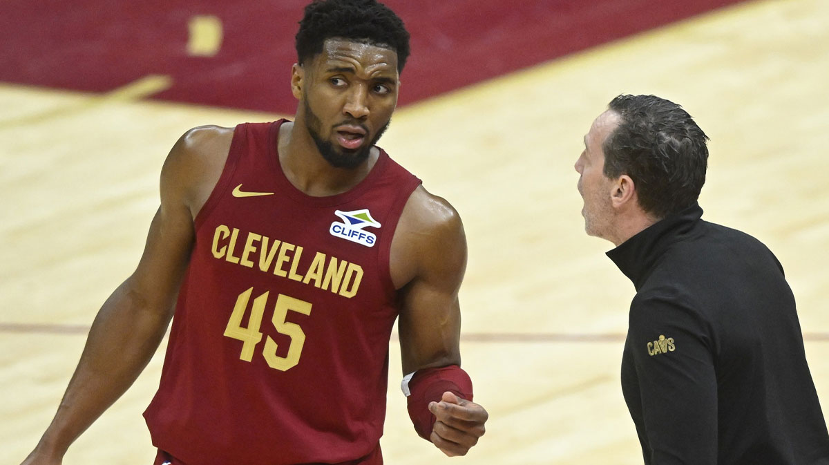 Cavaliers guard Donovan Mitchell (45) talks to head coach Kenny Atkinson in the fourth quarter against the Houston Rockets at Rocket Mortgage FieldHouse
