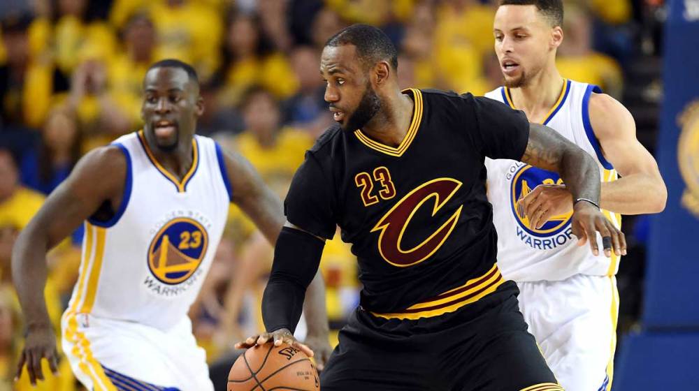Cleveland Cavaliers forward LeBron James (23) handles the ball against Golden State Warriors guard Stephen Curry (30) during the third quarter in game seven of the NBA Finals at Oracle Arena.