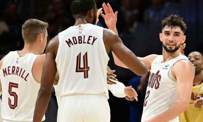 Cleveland Cavaliers guard Ty Jerome (2) celebrates after hitting a three point basket with guard Sam Merrill (5) and forward Evan Mobley (4) during the second half against the Toronto Raptors at Rocket Mortgage FieldHouse.