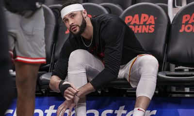 Atlanta Hawks forward Larry Nance Jr. (22) ties his shoe on the bench before the game against the Toronto Raptors at State Farm Arena.