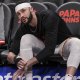 Atlanta Hawks forward Larry Nance Jr. (22) ties his shoe on the bench before the game against the Toronto Raptors at State Farm Arena.
