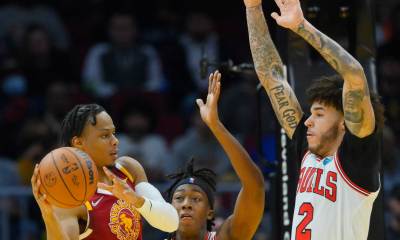 Chicago Bulls guard Ayo Dosunmu (12) and guard Lonzo Ball (2) defend Cleveland Cavaliers forward Isaac Okoro (35) in the third quarter at Rocket Mortgage FieldHouse.