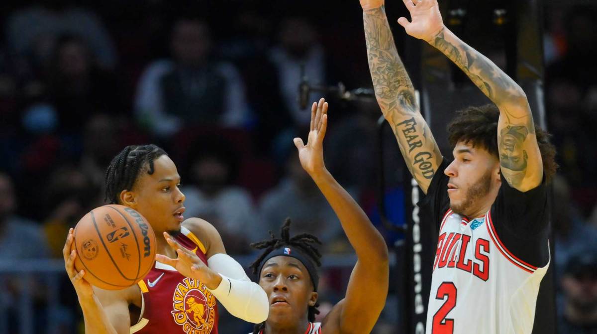 Chicago Bulls guard Ayo Dosunmu (12) and guard Lonzo Ball (2) defend Cleveland Cavaliers forward Isaac Okoro (35) in the third quarter at Rocket Mortgage FieldHouse.