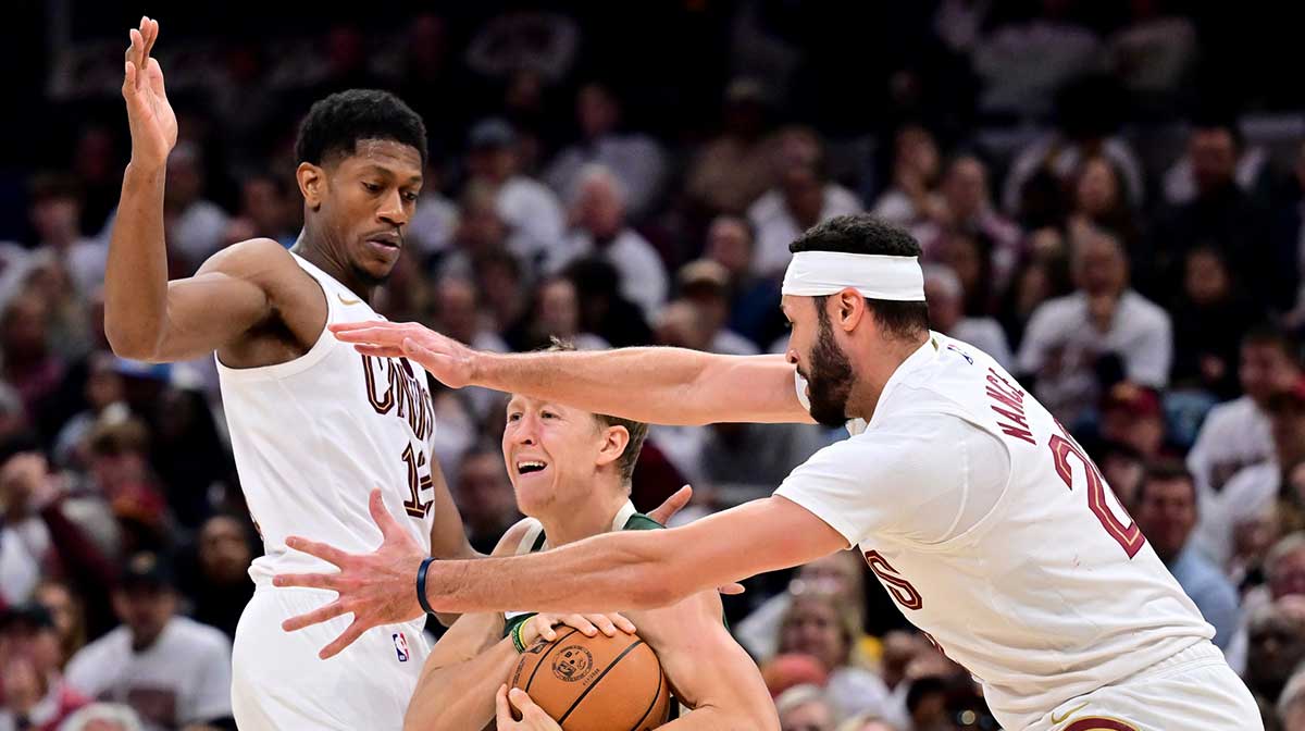 Cavaliers guard De'Andre Hunter (12) and forward Larry Nance Jr. (22) defend Milwaukee Bucks guard AJ Green (20) during the first half at Rocket Arena