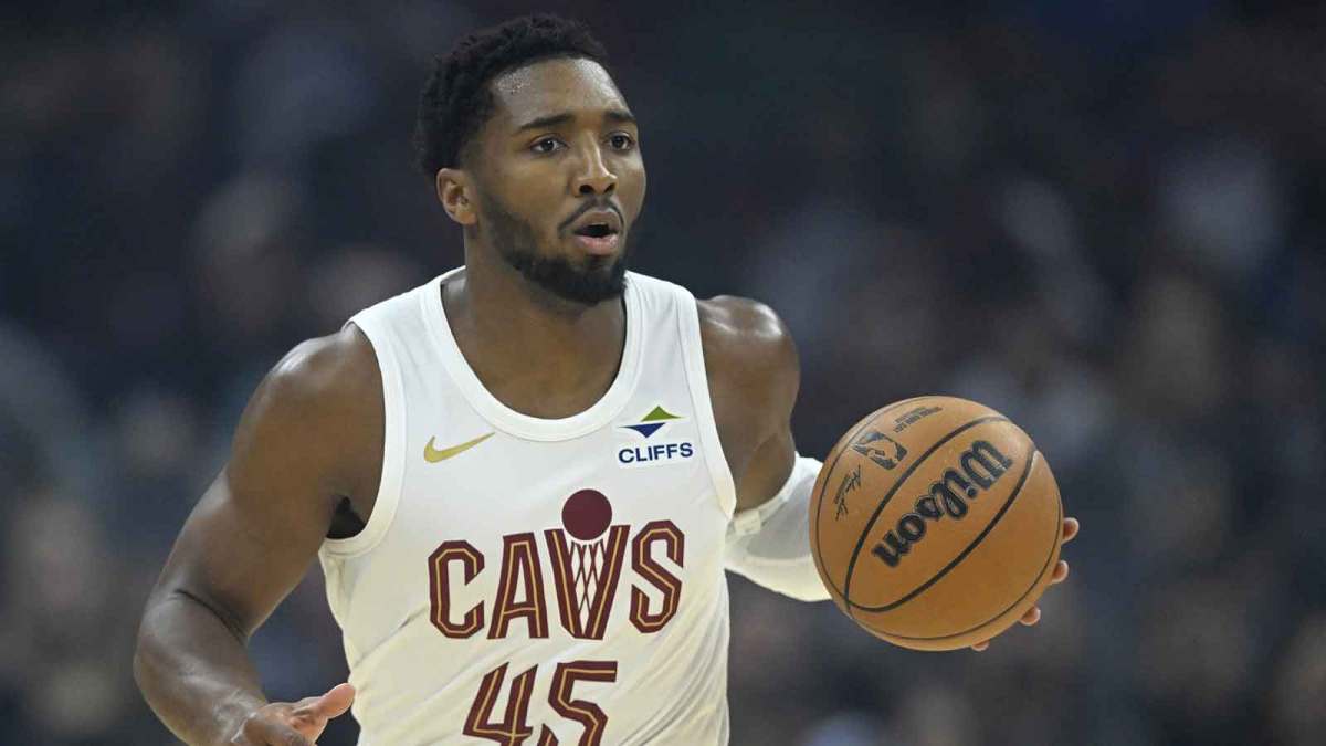 Cavaliers guard Donovan Mitchell (45) brings the ball up court in the first quarter against the Toronto Raptors at Rocket Arena with the Celtics logo in the background