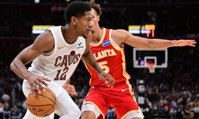 Cavaliers forward De'Andre Hunter (12) drives to the basket against Atlanta Hawks guard Dyson Daniels (5) during the second half at Rocket Arena with the Pacers logo in the background