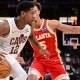 Cavaliers forward De'Andre Hunter (12) drives to the basket against Atlanta Hawks guard Dyson Daniels (5) during the second half at Rocket Arena with the Pacers logo in the background