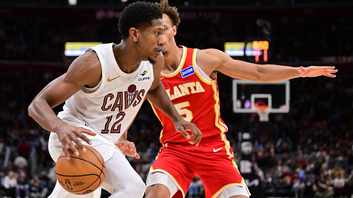 Cavaliers forward De'Andre Hunter (12) drives to the basket against Atlanta Hawks guard Dyson Daniels (5) during the second half at Rocket Arena with the Pacers logo in the background