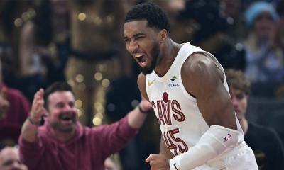Cavaliers guard Donovan Mitchell (45) reacts after being fouled and making the basket during the first half against the Phoenix Suns at Rocket Arena after the Cavs win with the Spurs and Suns logos in the background