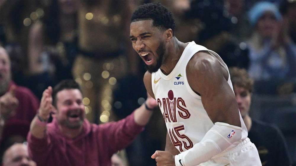 Cavaliers guard Donovan Mitchell (45) reacts after being fouled and making the basket during the first half against the Phoenix Suns at Rocket Arena after the Cavs win with the Spurs and Suns logos in the background