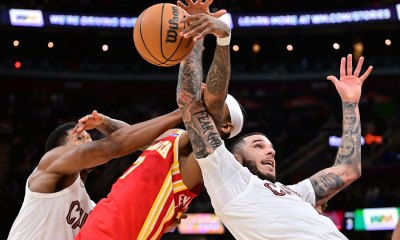 Cleveland Cavaliers forward De'Andre Hunter (12) and guard Lonzo Ball (2) go for a rebound against Atlanta Hawks guard Nickeil Alexander-Walker (7) during the second half at Rocket Arena