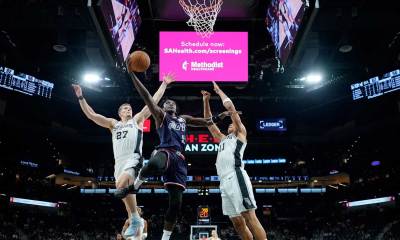 Guangzhou Loong Lions guard Victor Oladipo (52) drives to the basket between San Antonio Spurs forwards Riley Minix (27) and Carter Bryant (11) during the second half at Frost Bank Center.