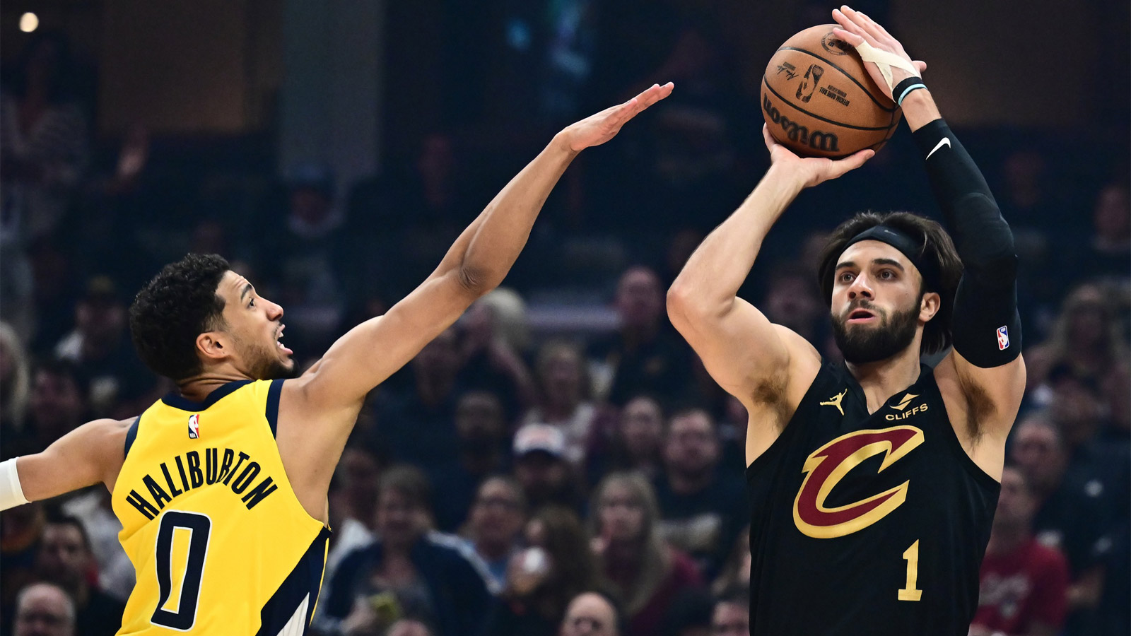 Cleveland Cavaliers guard Max Strus (1) shoots over the defense of Indiana Pacers guard Tyrese Haliburton (0) during the first quarter of game five of the second round for the 2025 NBA Playoffs at Rocket Arena.