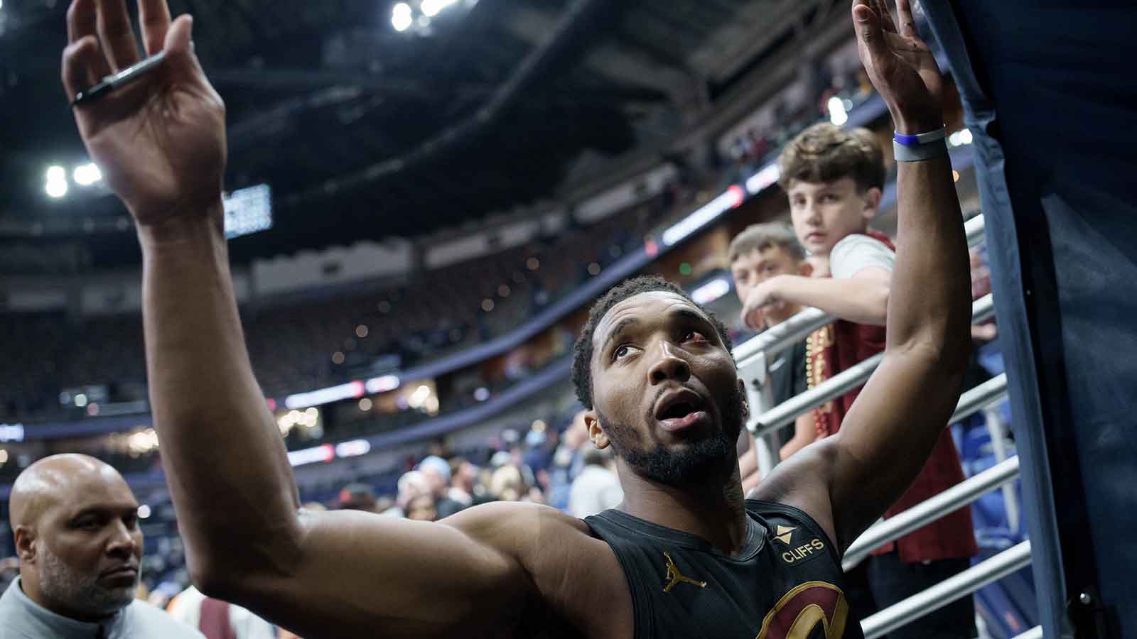 Cleveland Cavaliers guard Donovan Mitchell (45), whose left eye was bruised in a practice, high fives fans after a game against the New Orleans Pelicans at Smoothie King Center.