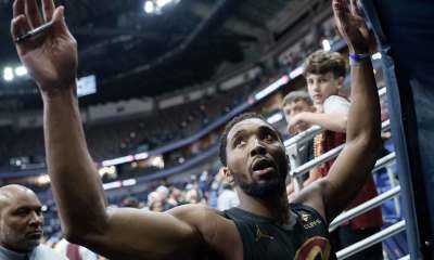 Cleveland Cavaliers guard Donovan Mitchell (45), whose left eye was bruised in a practice, high fives fans after a game against the New Orleans Pelicans at Smoothie King Center.