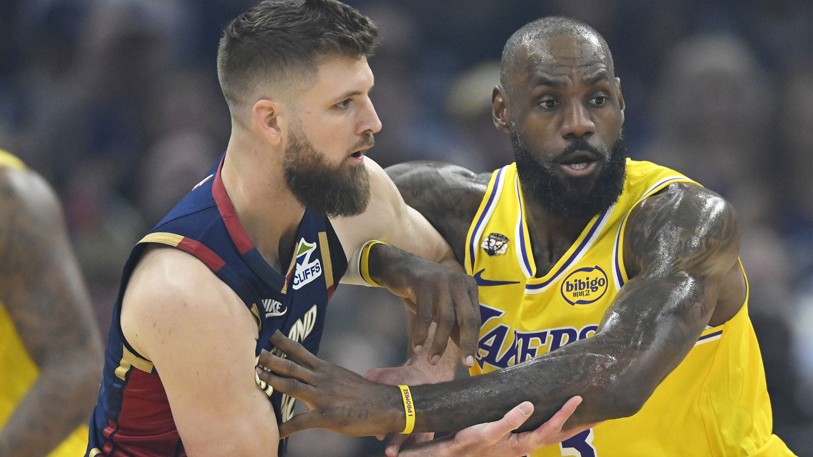 Cleveland Cavaliers forward Dean Wade (32) tries to get past Los Angeles Lakers forward LeBron James (23) in the first quarter at Rocket Arena.