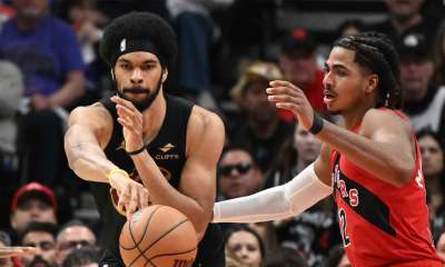 Cleveland Cavaliers center Jarrett Allen (31) passes the ball as Toronto Raptors forward Collin Murray-Boyles (12) defends during game four of the first round of the 2026 NBA Playoffs at Scotiabank Arena.