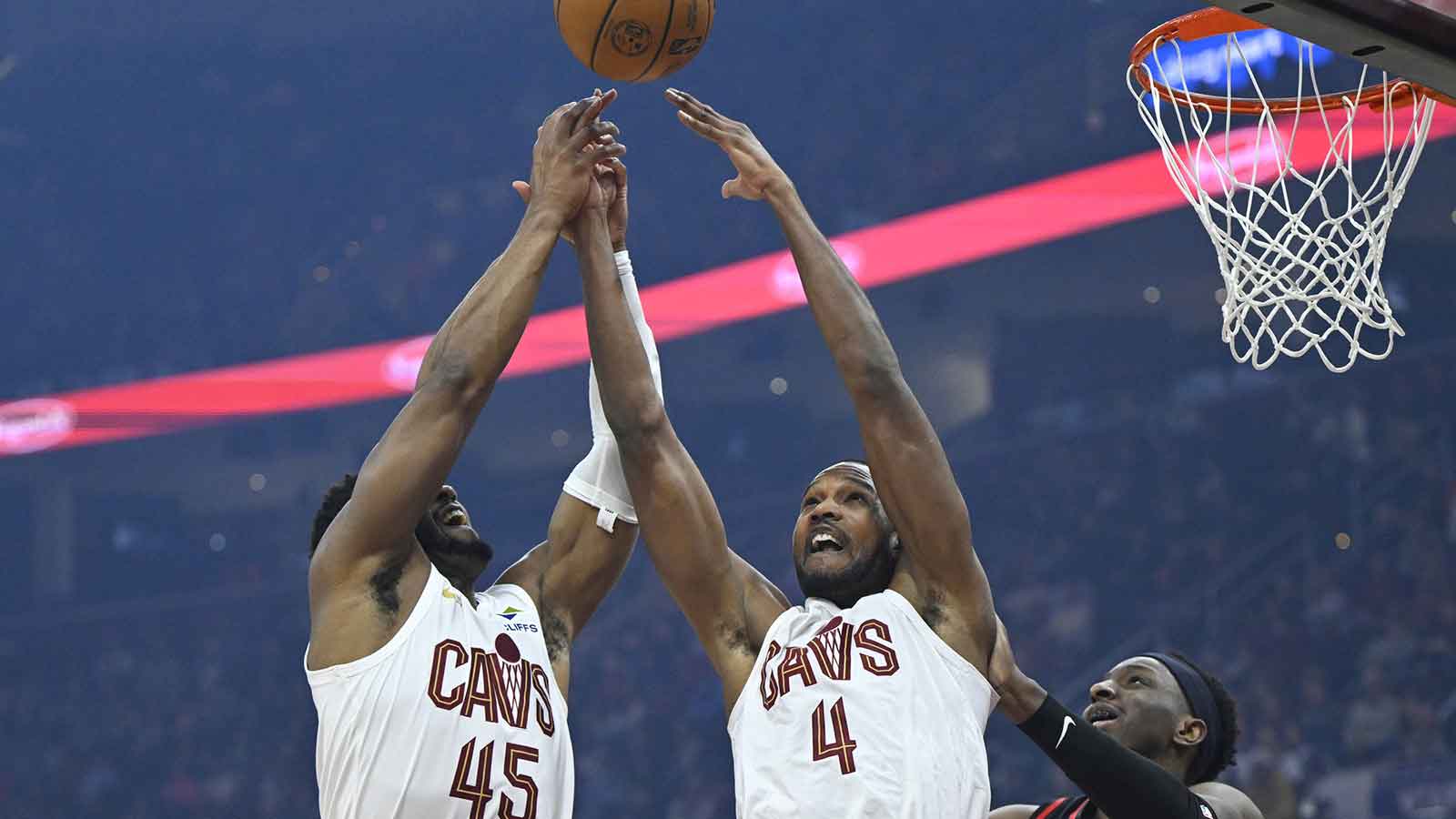 Cavs guard Donovan Mitchell (45) and center Evan Mobley (4) reach for the ball beside Atlanta Hawks forward Onyeka Okongwu (17) in the first quarter at Rocket Arena