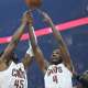 Cavs guard Donovan Mitchell (45) and center Evan Mobley (4) reach for the ball beside Atlanta Hawks forward Onyeka Okongwu (17) in the first quarter at Rocket Arena