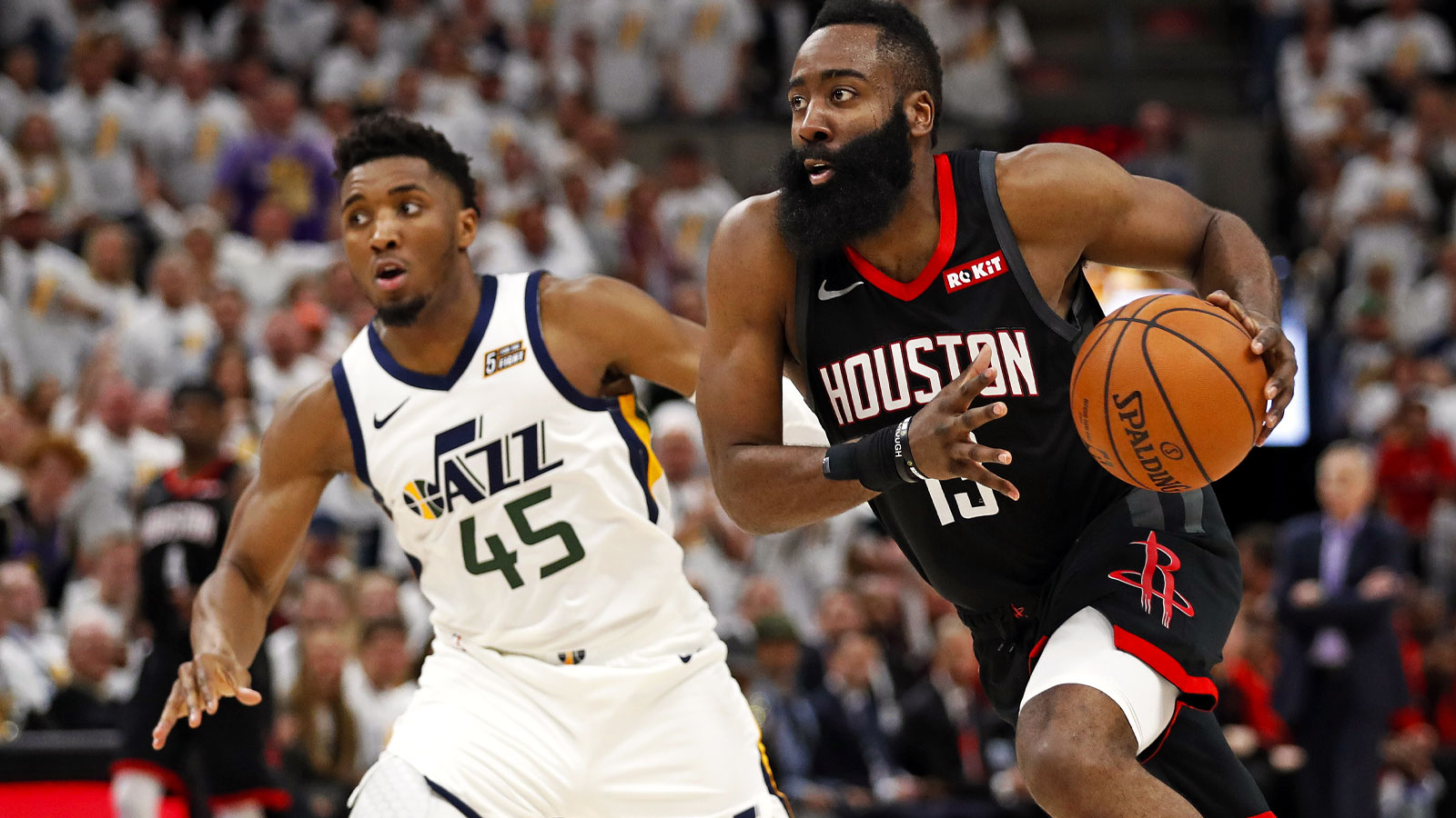 Rockets guard James Harden (13) drives to the hoop against Utah Jazz guard Donovan Mitchell (45) in the fourth quarter in game four of the first round of the 2019 NBA Playoffs at Vivint Smart Home Arena with Cavs logo in the background