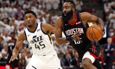Rockets guard James Harden (13) drives to the hoop against Utah Jazz guard Donovan Mitchell (45) in the fourth quarter in game four of the first round of the 2019 NBA Playoffs at Vivint Smart Home Arena with Cavs logo in the background