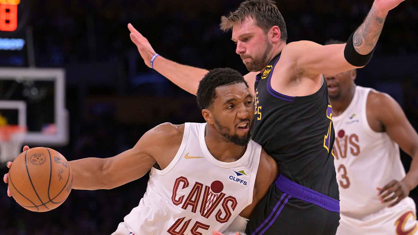 Cavaliers guard Donovan Mitchell (45) is defended by Los Angeles Lakers guard Luka Doncic (77) as he drives for a basket in the second half at Crypto.com Arena