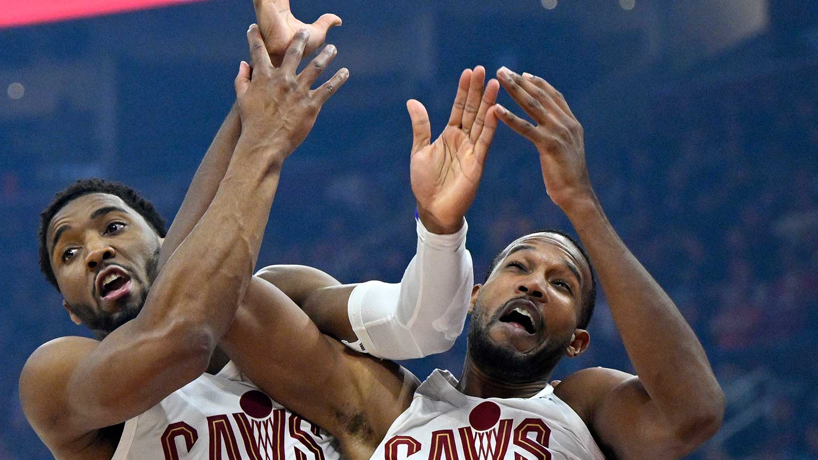 Cavs guard Donovan Mitchell (left) and center Evan Mobley (4) collide