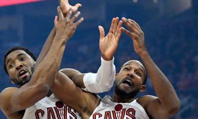 Cavs guard Donovan Mitchell (left) and center Evan Mobley (4) collide