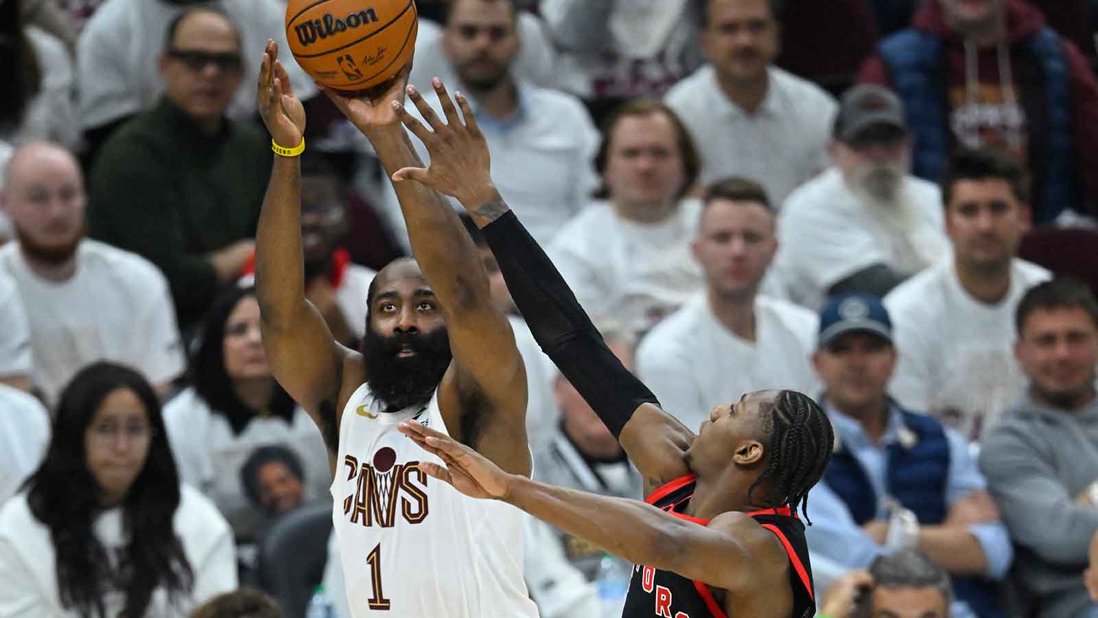 Cleveland Cavaliers guard James Harden (1) shoots beside Toronto Raptors forward RJ Barrett (9) in the third quarter of game five of the first round of the 2026 NBA Playoffs at Rocket Arena.