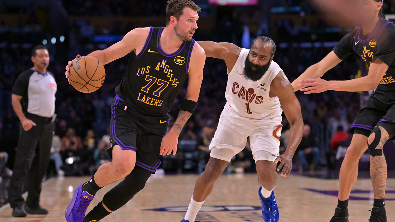 Los Angeles Lakers guard Luka Doncic (77) is defended by Cleveland Cavaliers guard James Harden (1) as he drives to the basket in the first half at Crypto.com Arena.