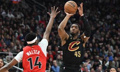 Cleveland Cavaliers guard Donovan Mitchell (45) shoots the ball against Toronto Raptors guard Ja'Kobe Walter (14) during game four of the first round of the 2026 NBA Playoffs at Scotiabank Arena.